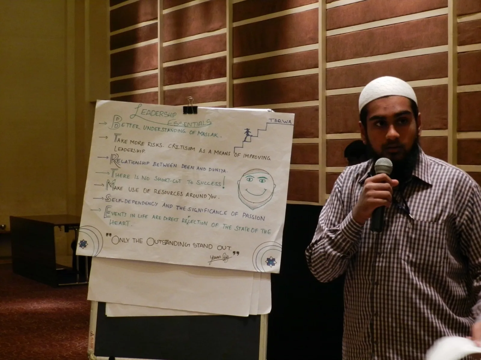 Participant presenting beside a Leadership Essentials flip chart